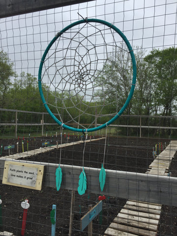 Dreamcatcher at Flowers blooming at The Healthy Living Land Based Learning Community Garden Project
