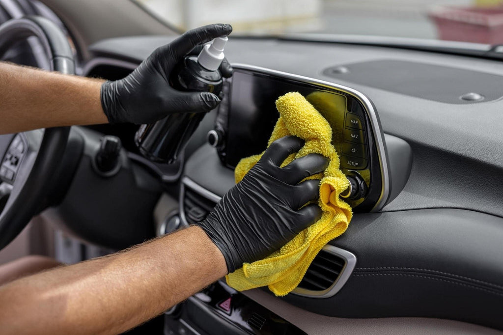 Hand cleaning the car interior with microfiber cloth towel car carez