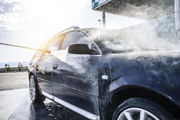 High-pressure washing car outdoors. Car washing under the open sky.