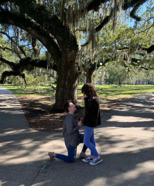 couple proposing with capucinne ring