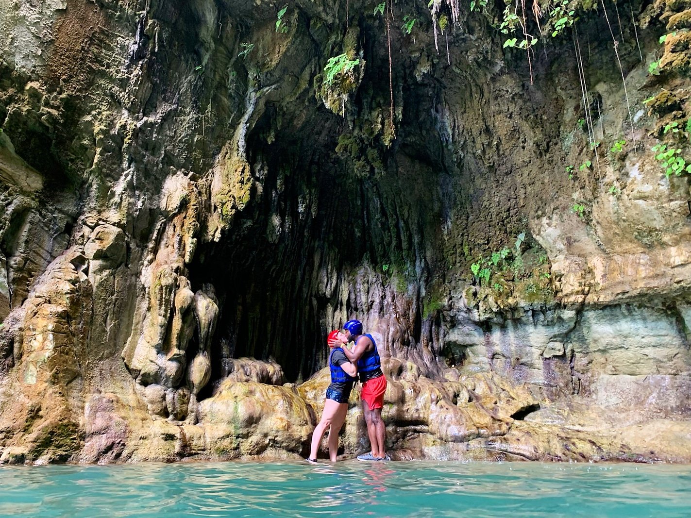 Caribbean couple under waterfall