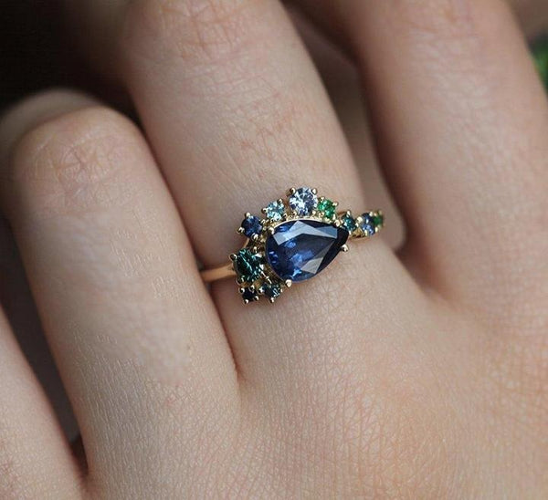 cluster sapphire diamond and emerald engagement ring