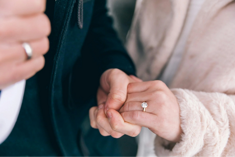 Couple holding hands with a oval stone promise ring