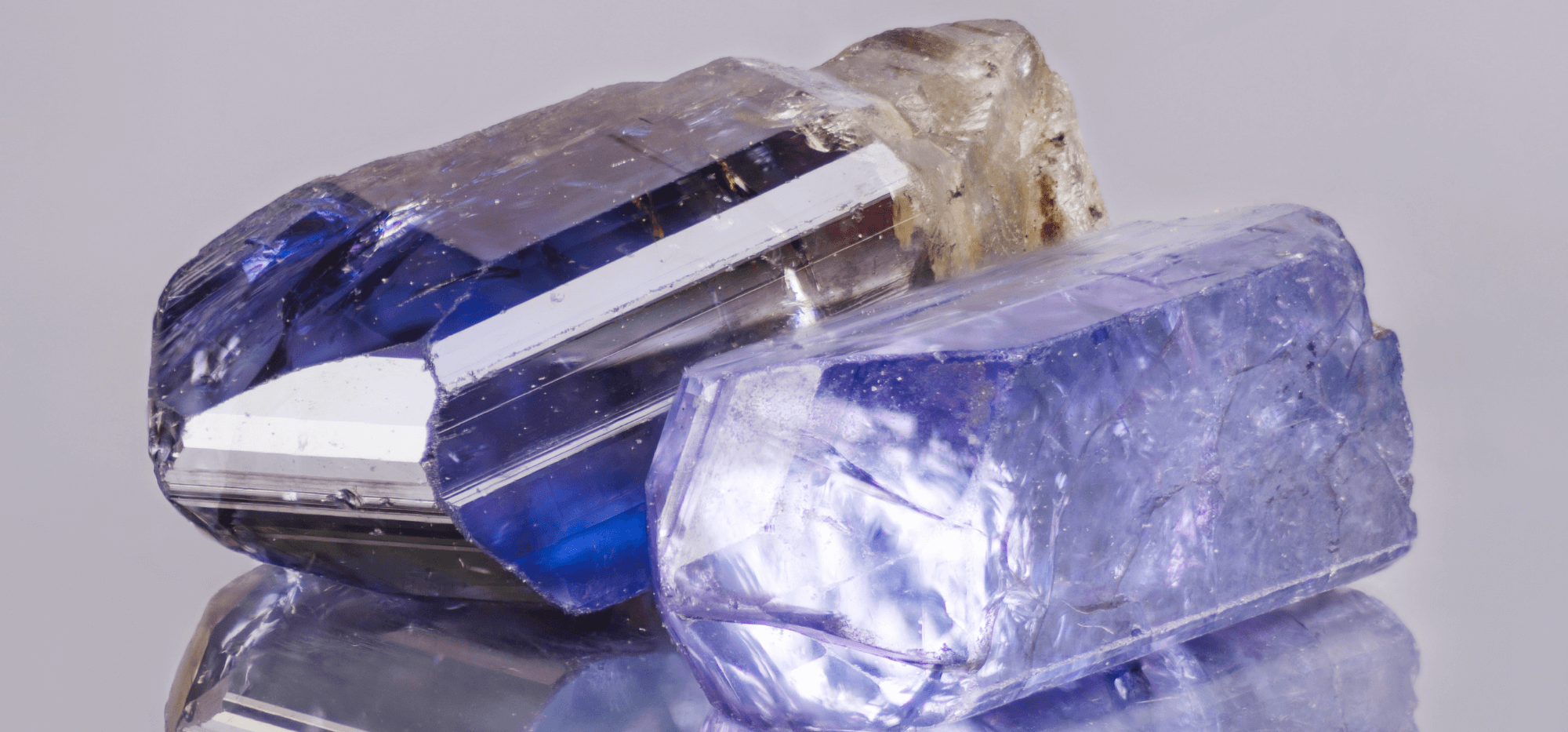 A raw Tanzanite stone in its unprocessed form, showcasing a rough exterior and deep, vibrant colors.