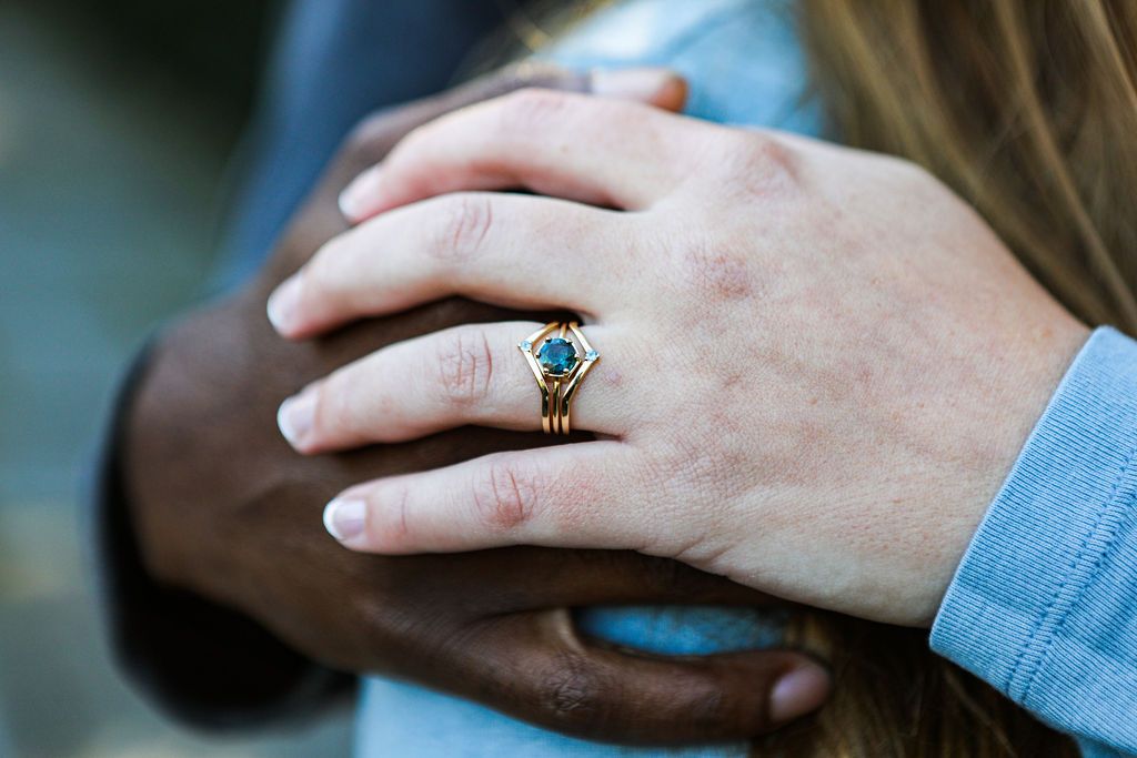 A girl wearing round sapphire ring on her index finger