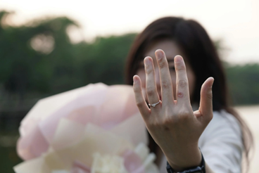 Woman holding up an engagement ring on her finger