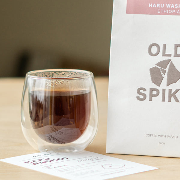 Old Spike filter coffee in a glass next to a bag of coffee