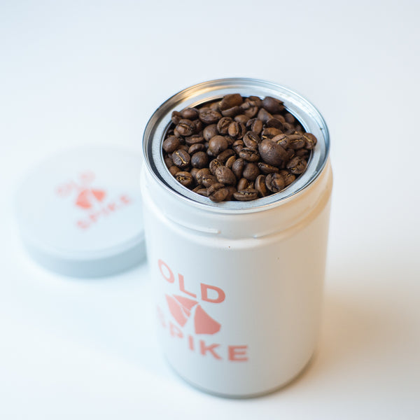 Old Spike coffee storage tin filled with specialty coffee beans