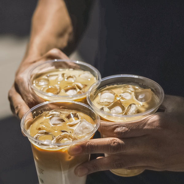 Person hold three Old Spike iced lattes  