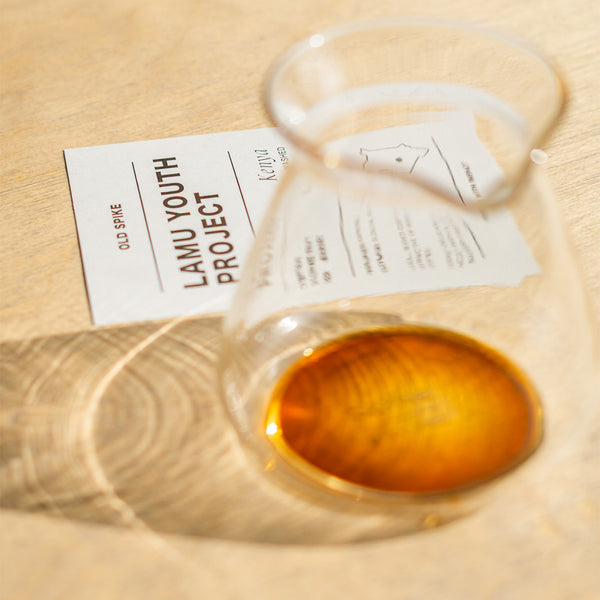 Filter coffee in a carafe on a wooden table with an info card