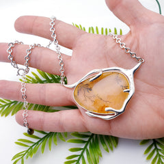 Dendritic quartz necklace in palm of hand