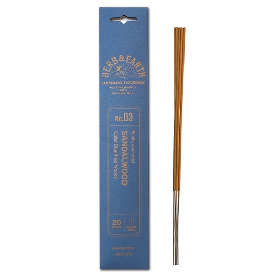 blue package with gold text and three incense sticks on right.