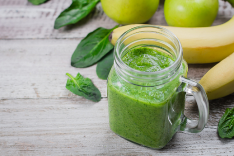 Organic Healhty Vegetarian Food. Fresh homemade raw vegetable and fruit green smoothie in mason jar with apple, banana and spinach leaves on shabby wooden background