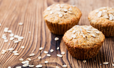 Healthy vegan oat muffins, apple and banana cakes on a wooden background.