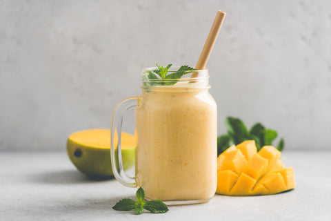 Delicious mango smoothie in glass jar stock photo