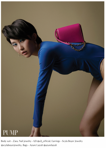 model bent over with pink azure lazuli handbag on back
