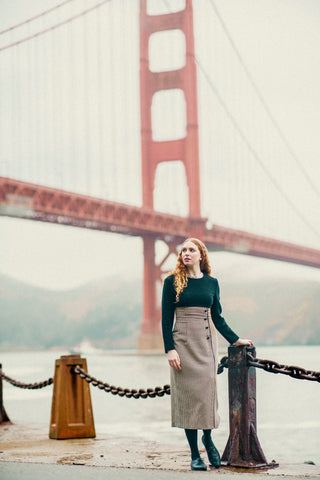 The iconic Golden Gate Bridge in the background, the model wears dress and shoes styled by Empress Vintage.