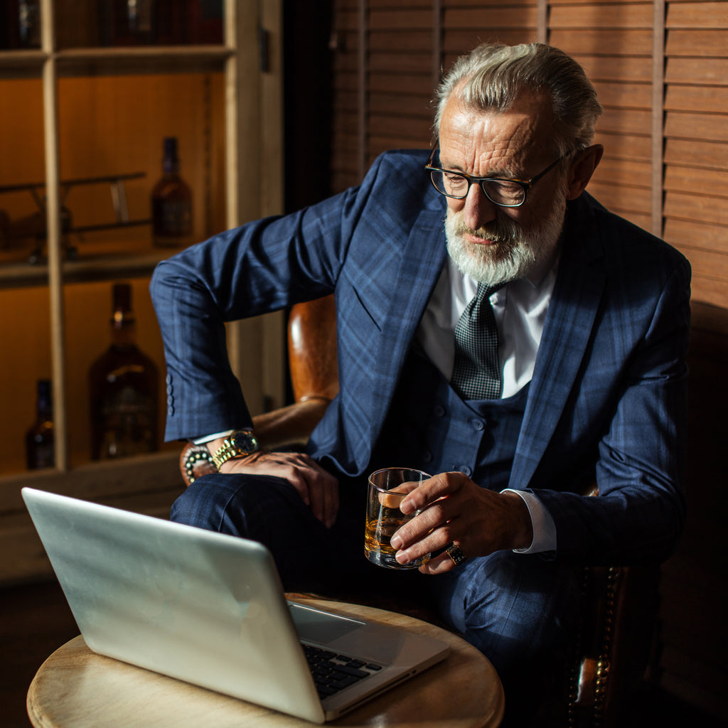 A man sits and drinks alcohol from an unbreakable tritan whiskey glass