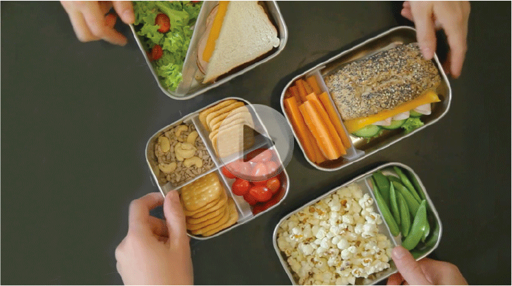 View from the top of several containers filled with healthy foods