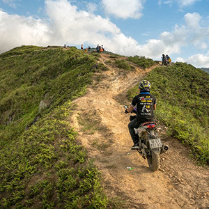 adventure motorbike rider wears pants on mountain