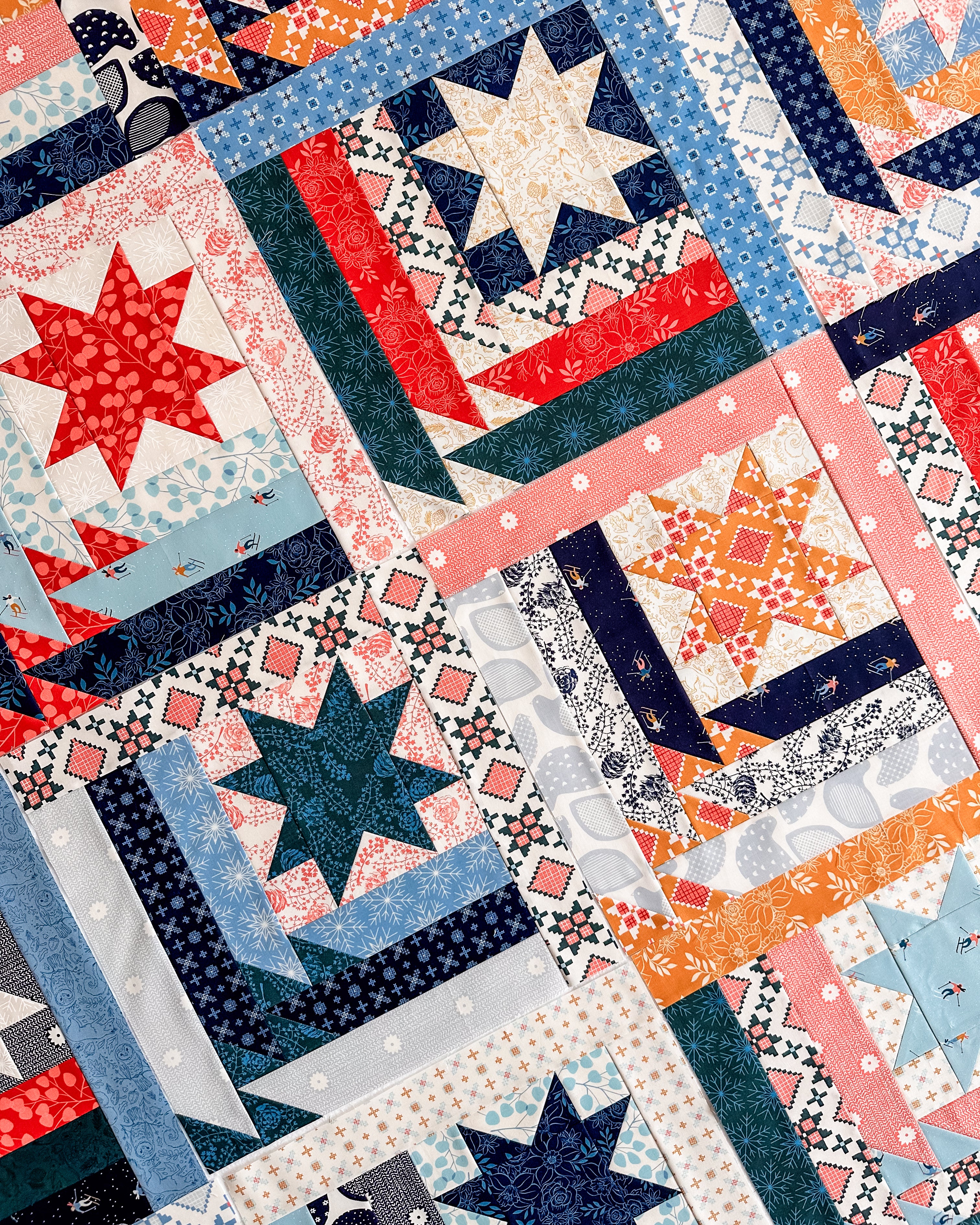 a scrappy version of the Mountain Valley quilt pattern made with Ruby Star Society Winterglow fat quarters