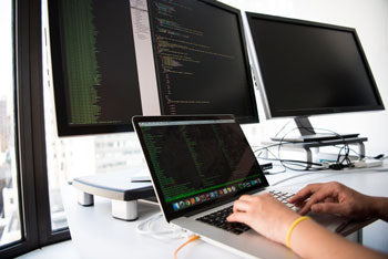 A multi-monitor setup for a computer coder