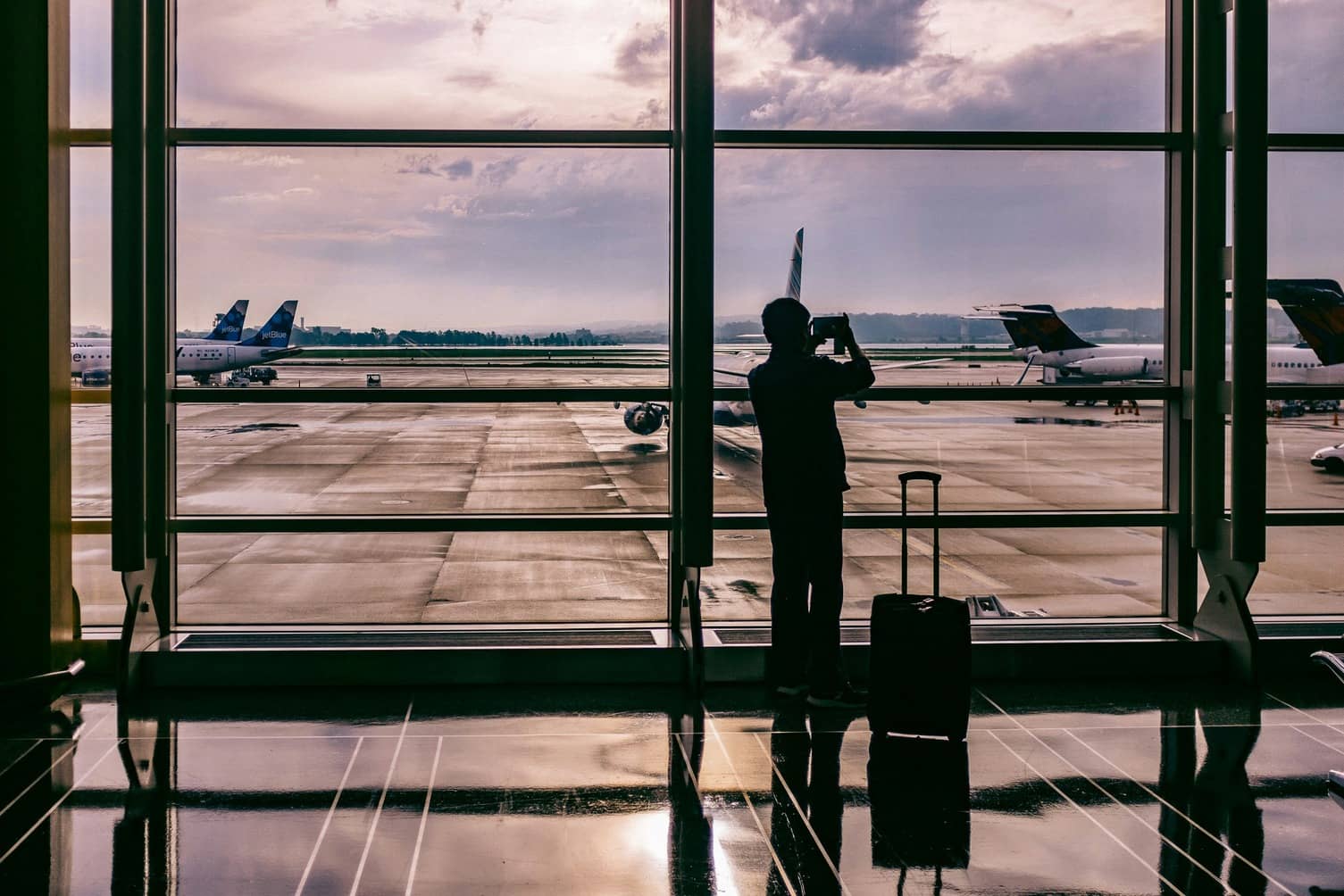 person standing at an airport window