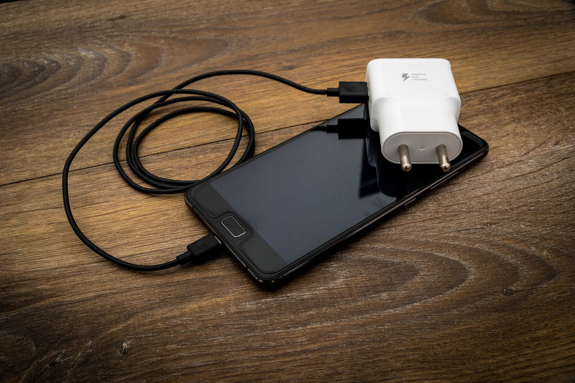black smartphone and charger travel tech accessories