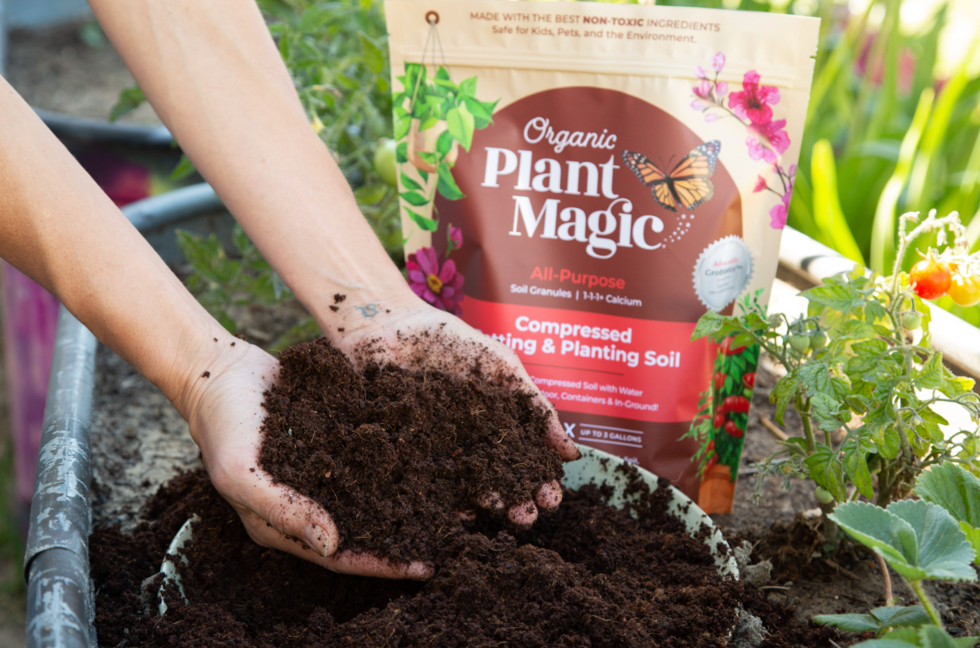 Pair of hands holding compressed soil with packaging in the background