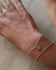 wrist with silver simple chain bracelet with clover charm and gold satellite dainty chain bracelet