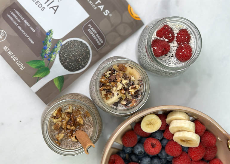 Three jars of different types of chia pudding made with Navitas Organics Chia Seeds, topped with various superfood toppings