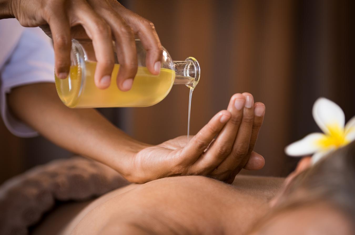 a masseuse pouring oil onto her hands for a massage acne prone skin maracuja oil for hair care anti aging properties potent antioxidants south america linoleic acid fatty acids