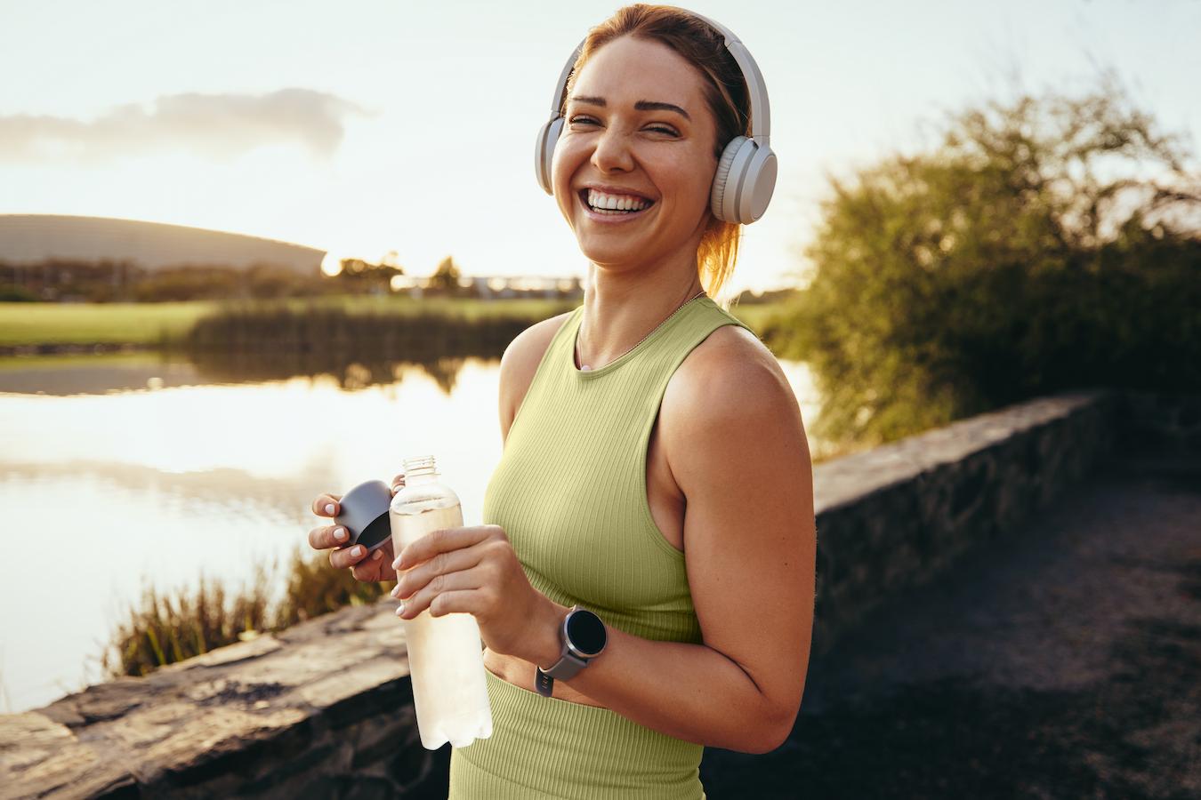 a woman smiling doing an outdoor workout positive outcomes human flourishing underlying mechanisms experimental research involves emotional well being overall mental health issues positive emotions emotional well being mental health