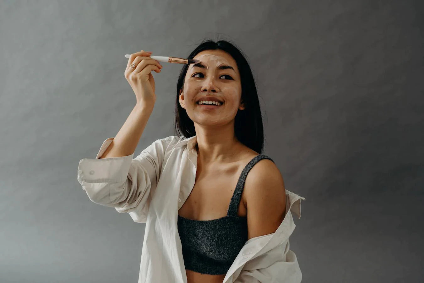 girl painting a face mask on her face papain xanthan gum titanium dioxide salicylic acid seed oil