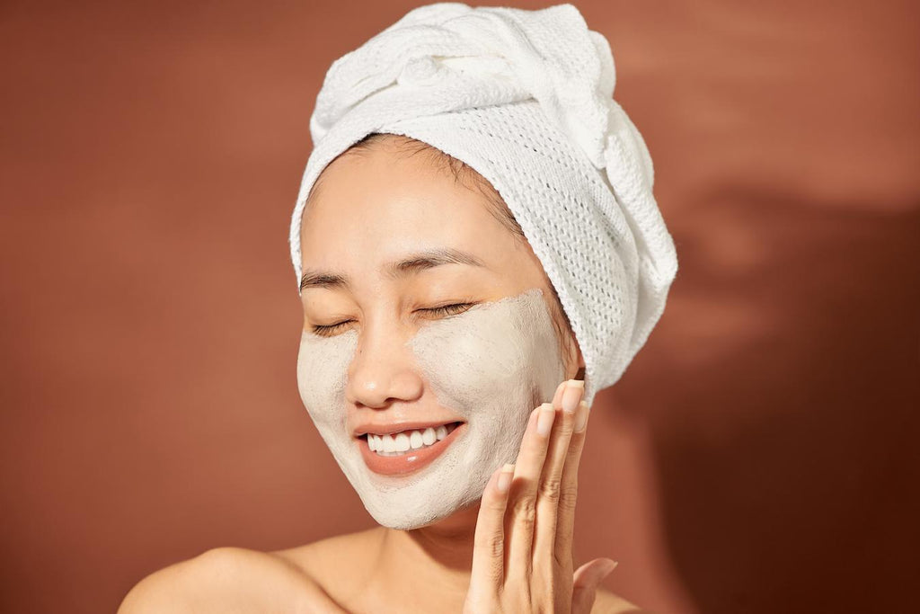 girl smiling while rubbing a beauty product onto her cheeks clog pores food processor cosmetic dermatology chemical peels skin type glycolic acid lactic acid skin health