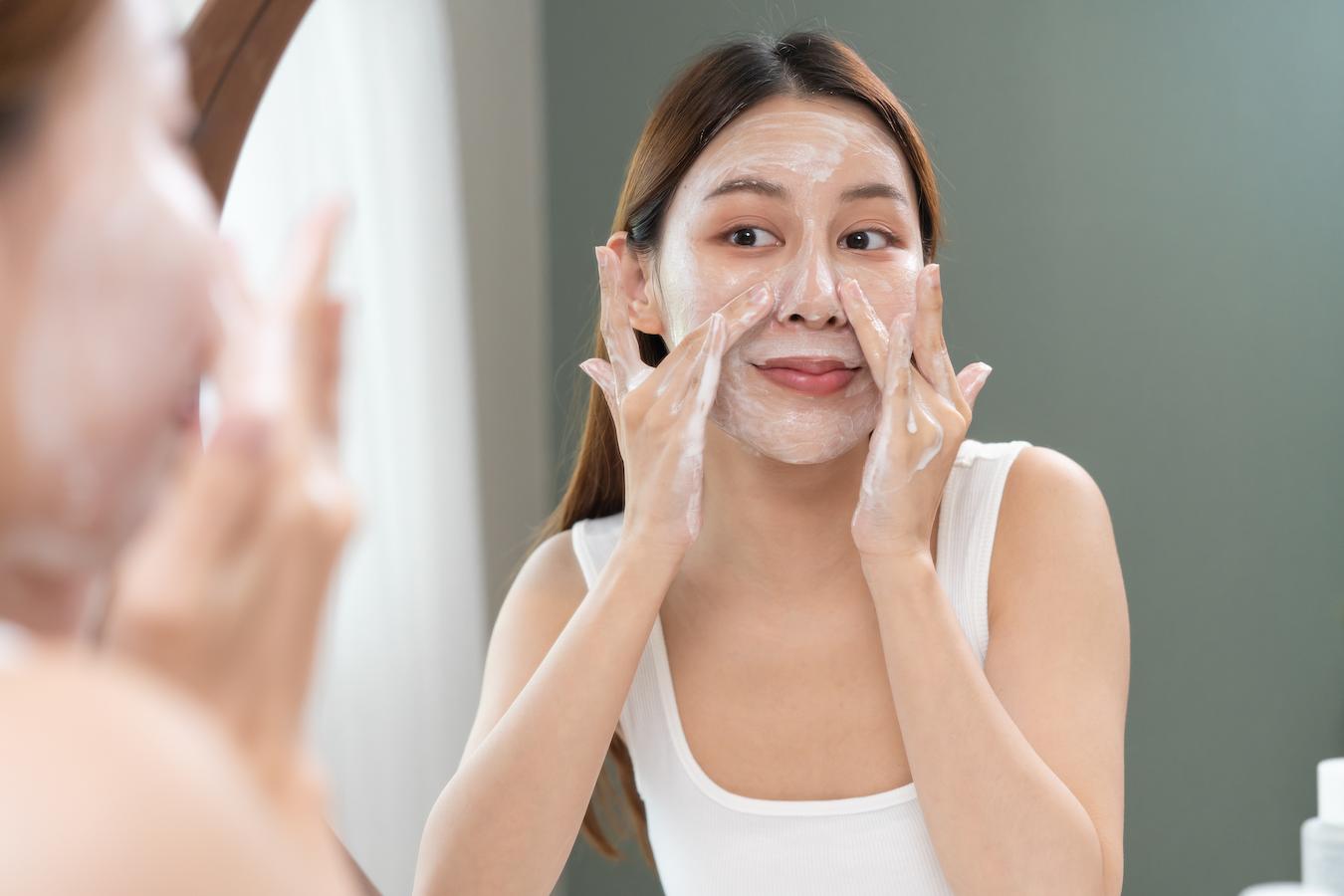 girl washing her face in the mirror lactic acid slightly damp more moisture harsh cleanser skin is dry outer layer benzoyl peroxide oilier skin peeling skin hydrating toner skin type skin conditions dry skin