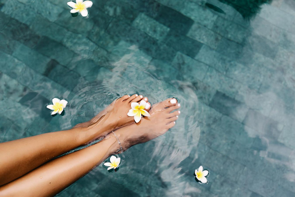 girls legs in a clear pool with floating flowers national wellness institute workplace health promotion natural substances mentally aided healing alternative systems influential academic publication infectious diseases modern disease oriented dietary and lifestyle change achieving health fairs wellness programs