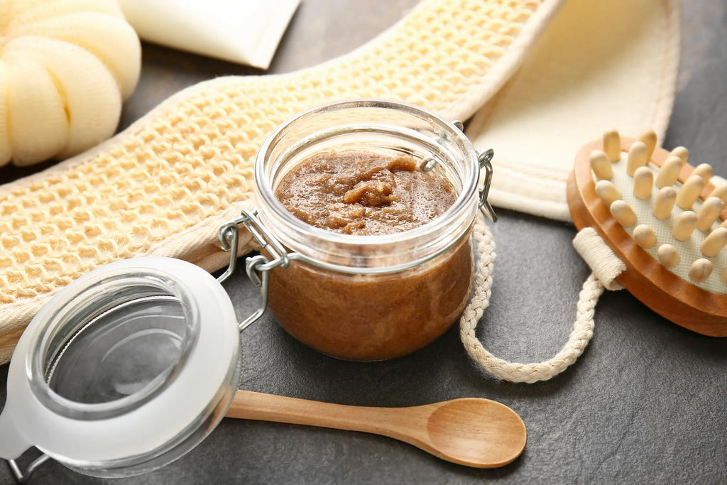 glass jar filled with a brown natural substance brown sugar almond oil lemon juice sea salt baking soda health body exfoliation coconut oil lemon juice sea salt baking soda