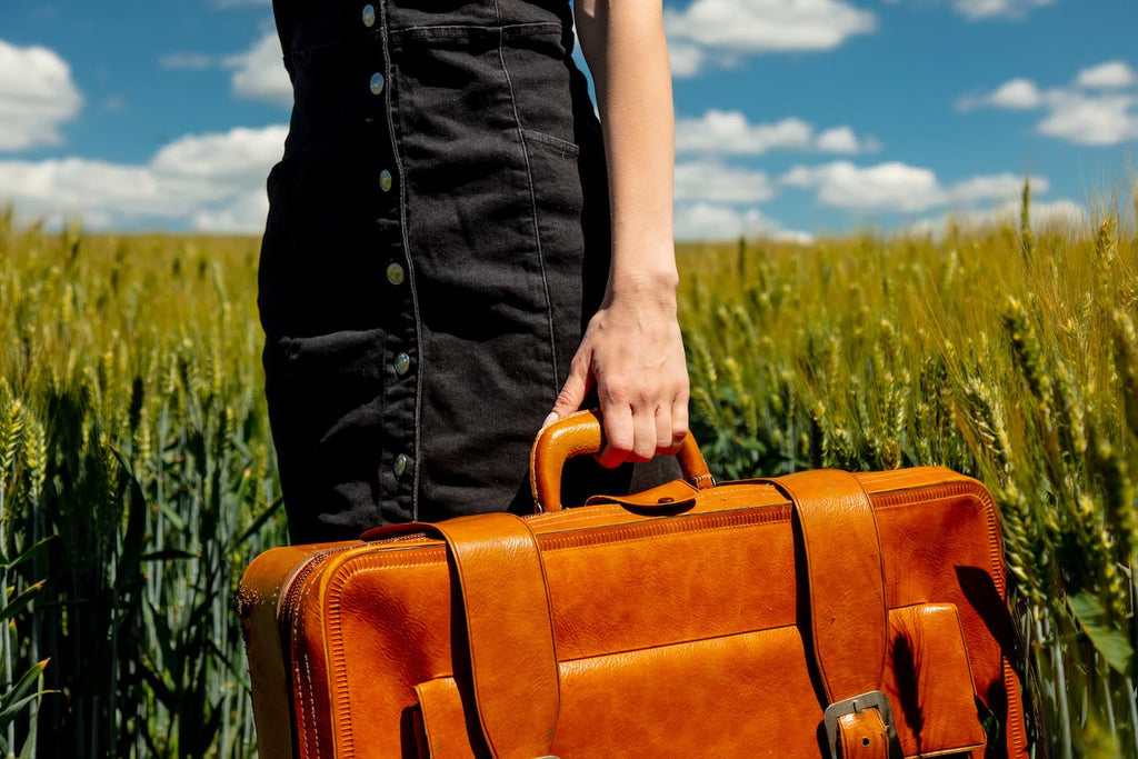 girl with an orange suitcase in a field kitchen sink pack side note liquids opt cleanser trip oil sunscreen bag pack pack travel sizes liquids luggage liquids pack trip trip trip sunscreen sunscreen cleanser cleanser routine travel skincare routine