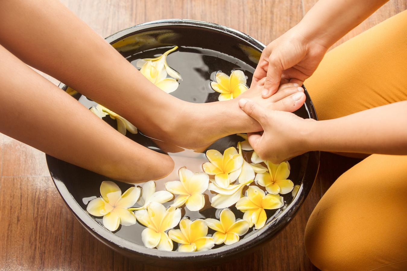 someone getting a foot bath with flower petals cosmetic products body washes pagoda tree deciduous shrub potent antioxidant