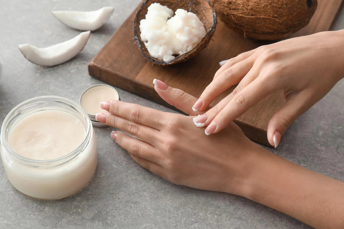 someone rubbing coconut oil into their hands very little fat padding only one treatment