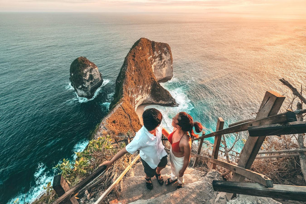 two people walking up stairs outdoors looking back at a rocky beach cia world factbook thousand islands geographical history ministry official leading western half other countries tiny islands largest country malaysia ethnic groups main islands indonesia other countries