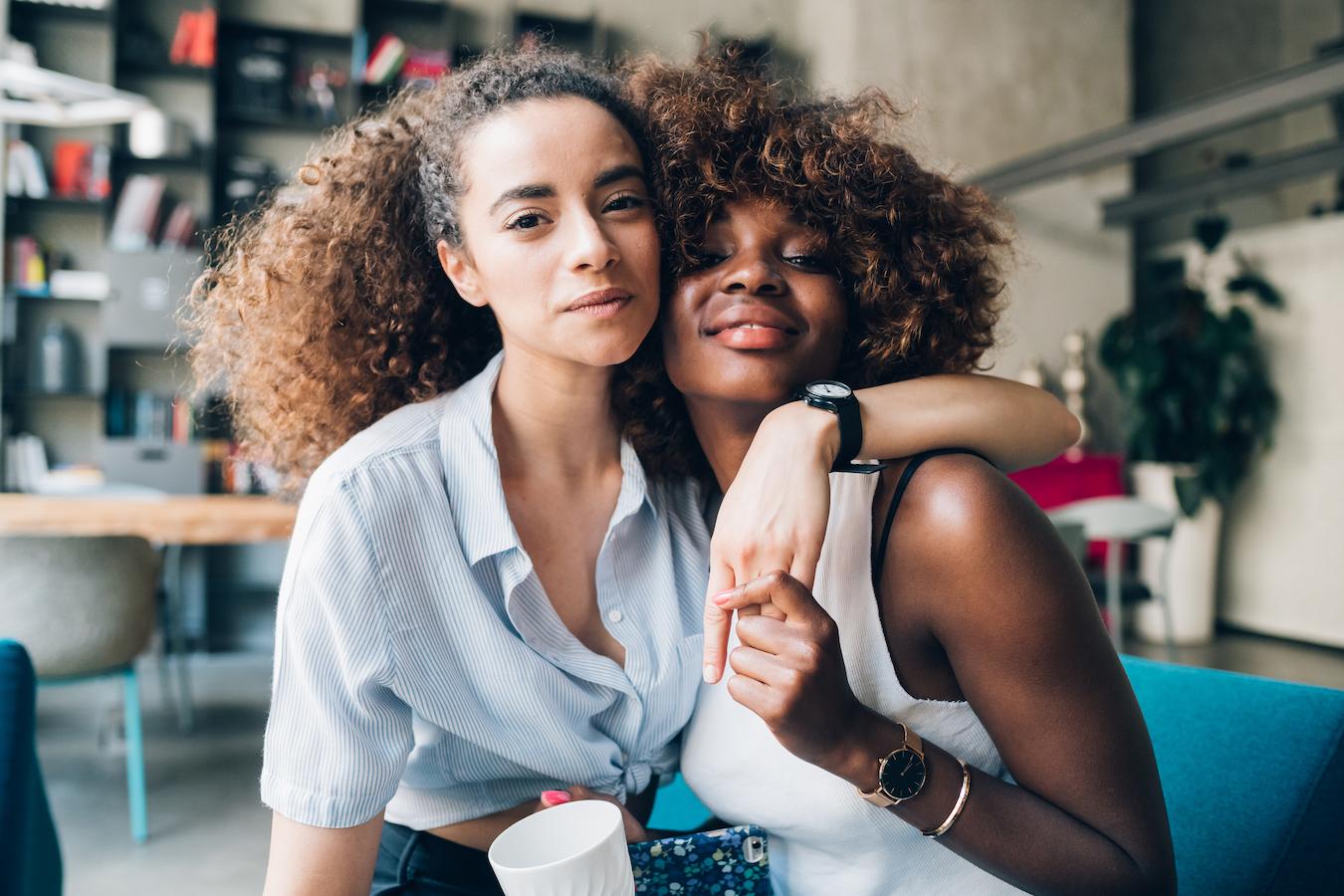 two women sitting together hugging academic and professional lives encourage communication family's health habits support support