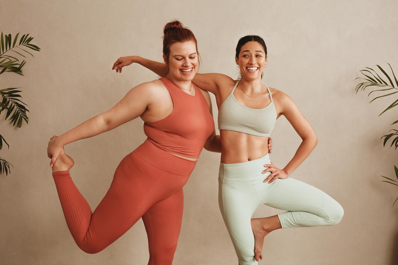 two women wearing yoga outfits active approach discussing health life disease overall wellness good health spiritual health physical activity physical activity