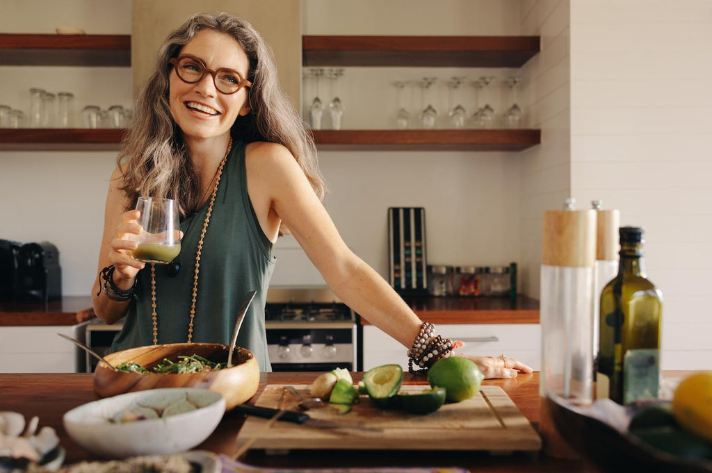 woman smiling while drinking a green smoothie ginger turmeric tea ginger tea good scientific evidence cholesterol levels anti cancer properties turmeric tea ginger tea