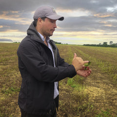 Farmer Jo, holding a sprig of Peppermint