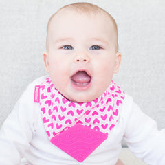 baby wearing bandana bib pink hearts