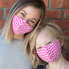 mom and daughter wearing booginhead masks pink hearts