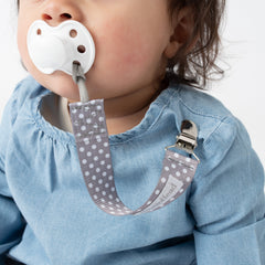 baby using BooginHead pacifier clip gray polka dots