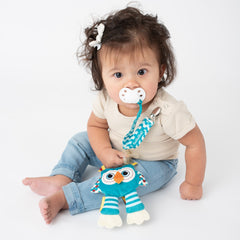 Baby using BooginHead PaciPal Owl pacifier holder